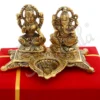 A 5x5 inch Gold Plated Aluminium Deep Lakshmi Ganesh Gift in a velvet box, perfect for auspicious occasions.