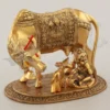 A beautifully crafted Gold Plated Aluminium Cow Calf Laddu Gopal statue for spiritual home decor.