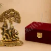 A beautiful Gold Plated Aluminium Radha Krishna Velvet Box, depicting Radha and Krishna under a tree, presented in a luxurious velvet box.