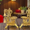 Gold plated peacock double diya stand set in a premium velvet box.