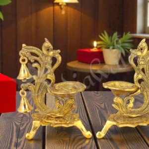 Gold plated peacock double diya stand set in a premium velvet box.