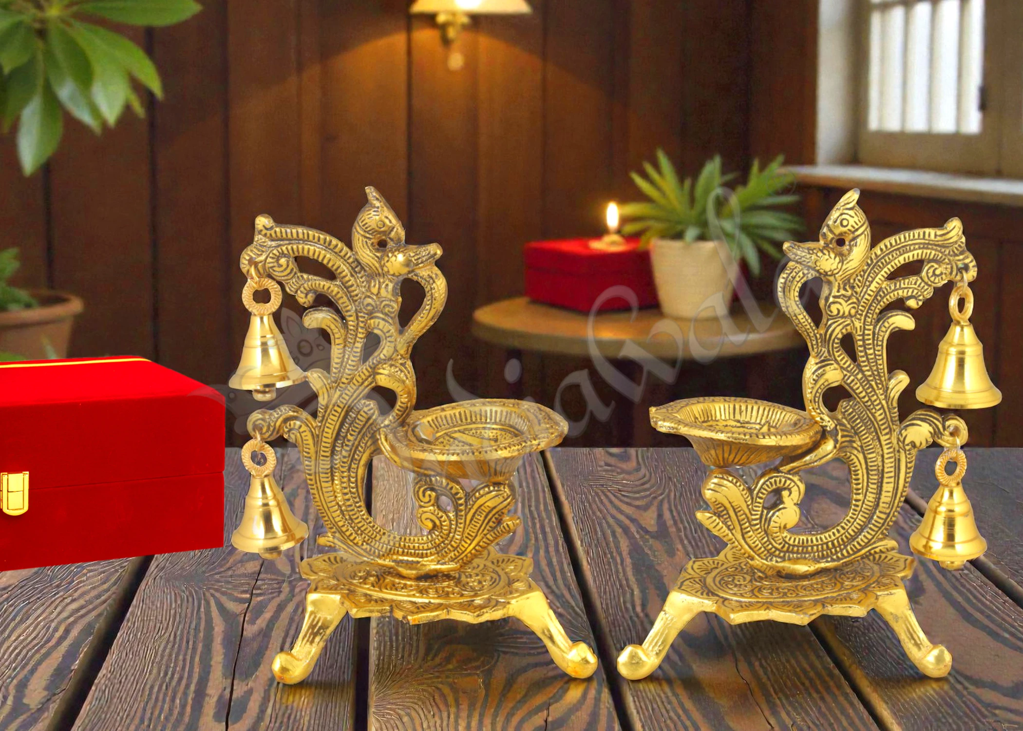 Gold plated peacock double diya stand set in a premium velvet box.