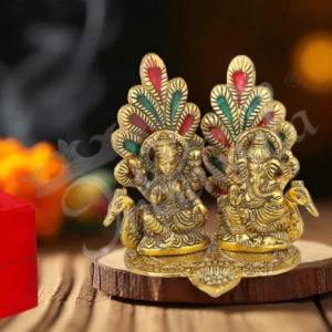 A stunning 5.5 Inch Gold Plated Aluminium Peacock Lakshmi Ganesh Gift in a velvet box.