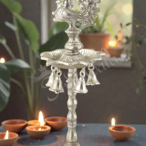 A beautiful 17.5 Inch Silver Plated Aluminium Peacock Diya Stand with intricate detailing.