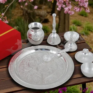 An 8 inch flower design silver plated aluminium pooja thali with intricate detailing.