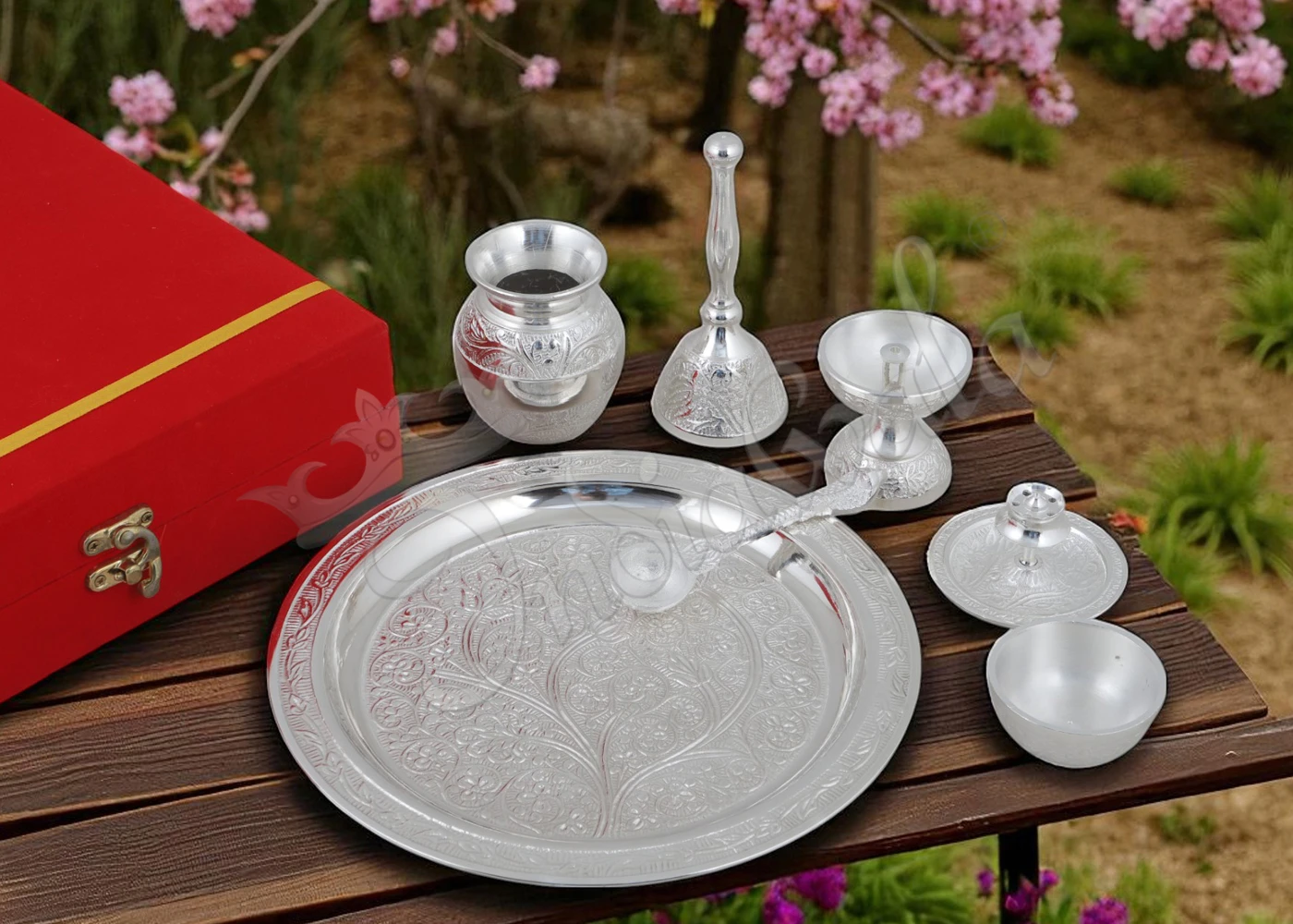 An 8 inch flower design silver plated aluminium pooja thali with intricate detailing.