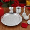 An 8 Inch Swastik Silver Plated Aluminium Pooja Thali with intricate design.