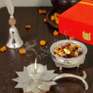 Elegant silver plated pooja bell diya bowl set in a premium velvet box.