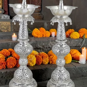 A pair of 20.5 Inch Silver Plated Brass Peacock Diya Stand Pair, perfect for festive decor and gifting.