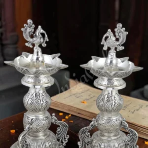 A beautiful 12 inch silver plated brass peacock diya stand pair, perfect for spiritual decor.