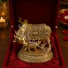 Handcrafted antique brass kamdhenu cow statue in a premium velvet box