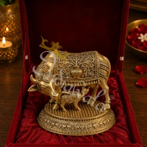 Handcrafted antique brass kamdhenu cow statue in a premium velvet box